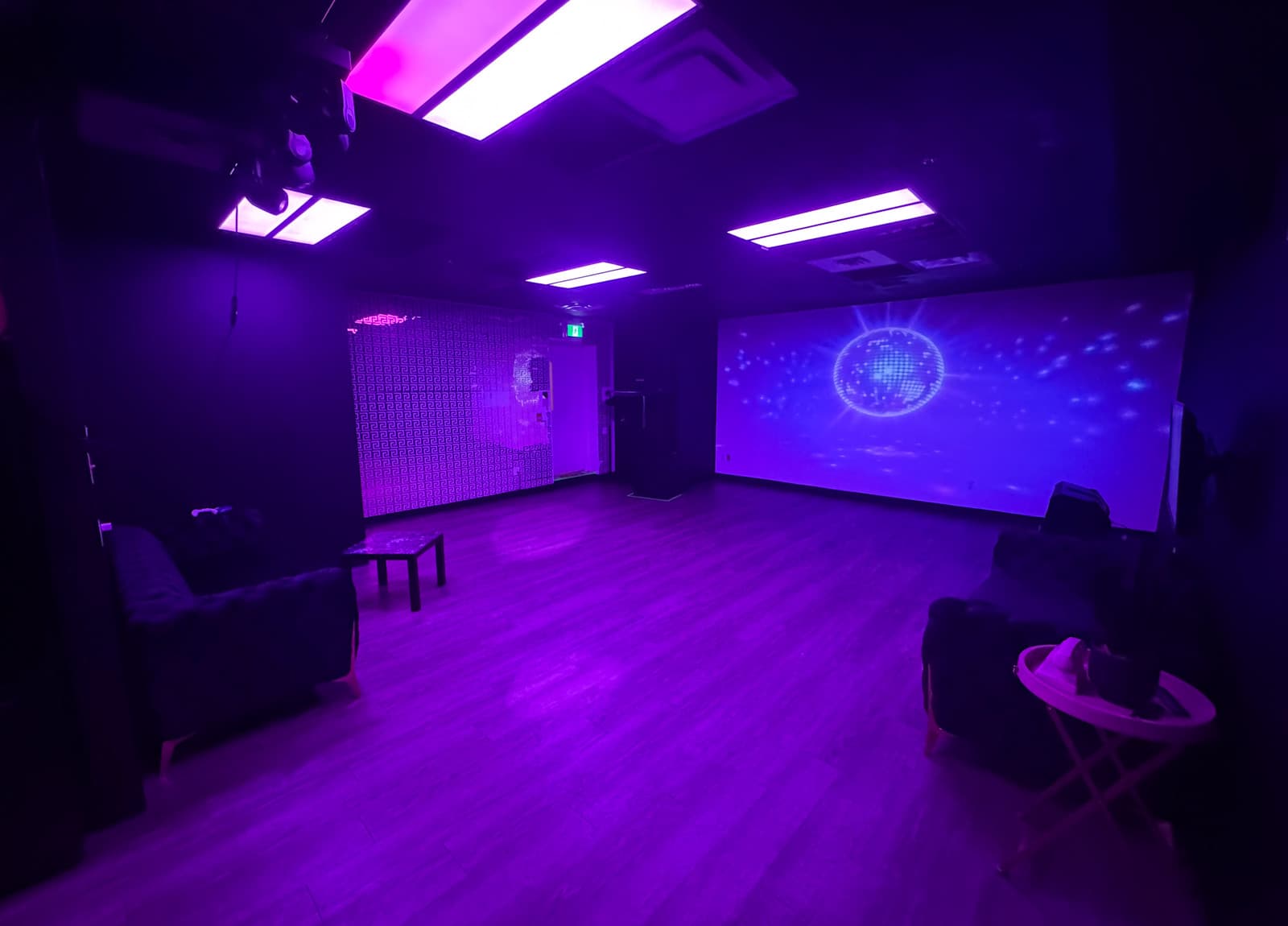 Lush Lounge room in purple ambient light with disco ball projection